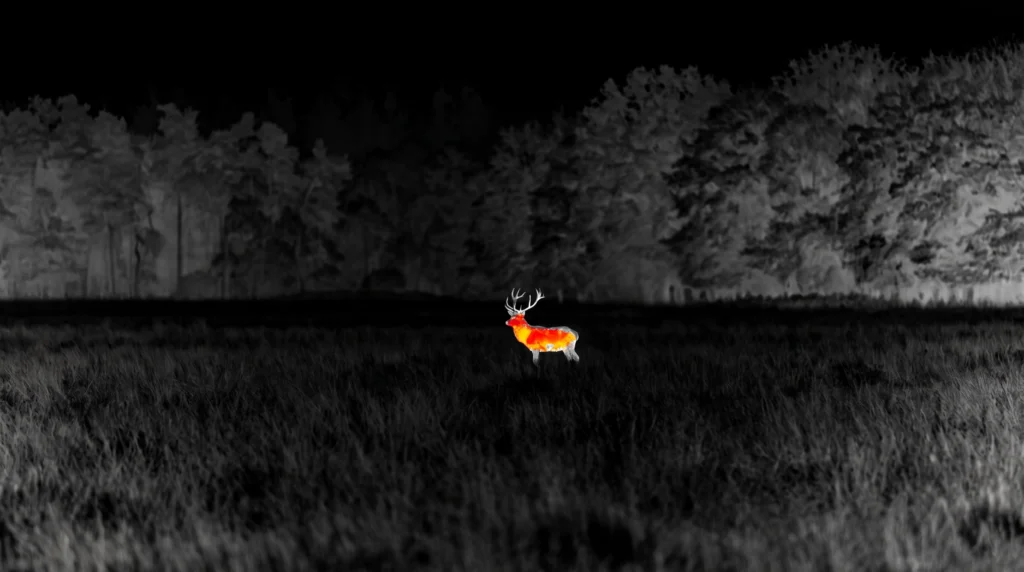 Field-edge scene with a conceptual thermal overlay showing a warm-bodied animal against the background